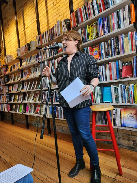 Various poets standing or sitting in Milkweed Bookstore, in front of filled bookcases, reading poetry.