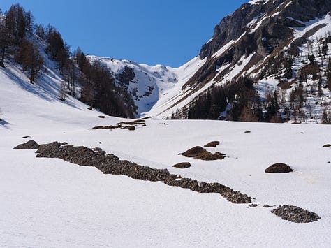 Images of people on ski tour, skinning up in a line behind each other.