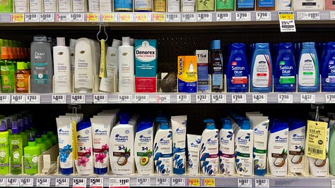 Shelves of hair-care products, hip-hop themed chips, and meals in a box.