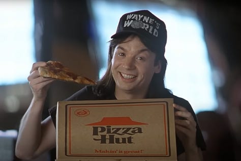 Mike Meyers with a box of Pizza Hut Pizza in the Product Placement scene in Wayne’s World (1992) with Rob Lowe | Film Flavor: A Newsletter Surveying Food in Film