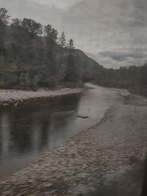 The first image shows a mountain gully with a river running through it. The second is a sunset over a large lake. The third shows another river with a rocky bank on one side and coniferous forest on the other