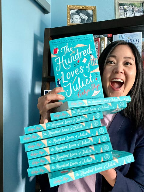 Author Evelyn Skye trying--and failing--to balance the giant stack of THE HUNDRED LOVES OF JULIET paperbacks