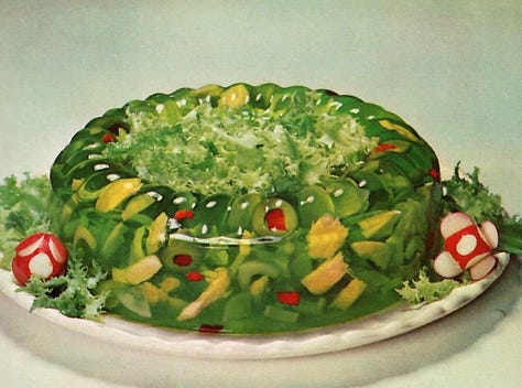 Image of a Perfection salad tower of gelatin, a ring of green tuna and lime gelatin salad, and 4 mini towers of congealed barbecue sauce