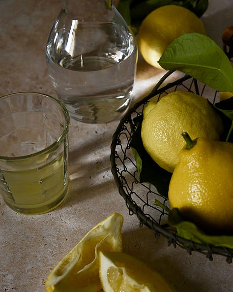 Three still lifes with lemons, whole and quartered, sunlit in southern France