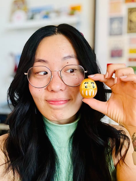 First photo of me smiling really wide, second photo of me with the golden daruma, and the last photo of the golden daruma itself, pictured with the fortune.