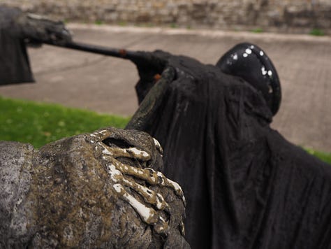a statue of death in the backgarden