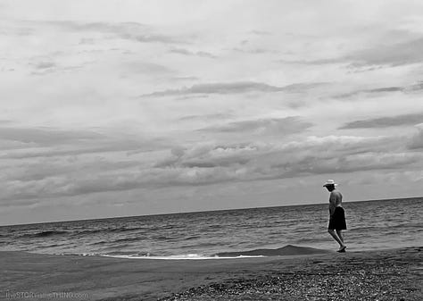 Man in hat walking along the Atlantic OCean beach