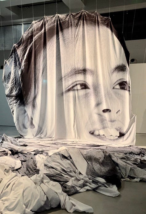 Una delle opere di Jr, l'ingresso di Camera Torino e una delle foto di Eve Arnold in esposizione