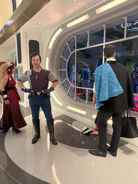 1st image: two scoundrels talking with avid interest; 2nd image: Noah with SK-620, a blue bronze and white astromech droid; 3rd image: Raithe Kole and some passengers in front of the bridge