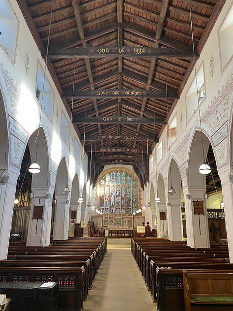 Left: a grey stone church building against a blue sky. Center: a church interior featuring columns with text and decorative stenciling, a wooden roof with Scripture verses on the crossbeams, and a chancel with stained glass. Right: a column with 2 Timothy 4:2 written on it.