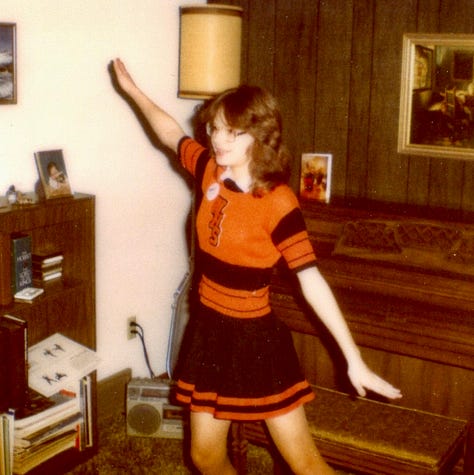 The author in three different black and orange cheer uniforms.