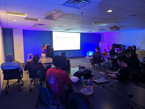 Image 1: Community members chatting and testing out games on display. Image 2: Two women sitting in front of a game called Torso Tennis. Image 3: Heather Chandler at front of the room talking about game production.