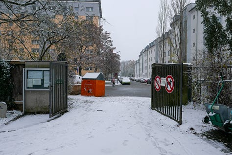 Snowy photos showing paths through an old cemetery and a wide, hostile looking ring road.