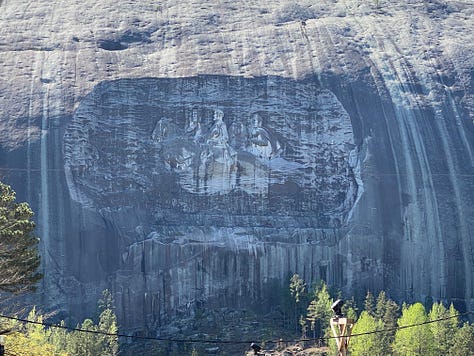 Images of confederate soldiers carved into the side of a mountain, then several photos of objects from the gift shop that have the same image; and the last photo is of a racially mixed group of school children on a field trip