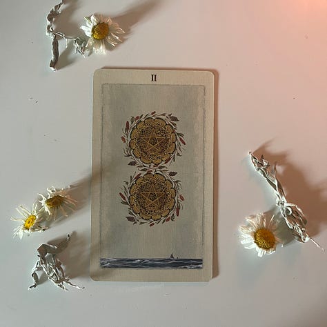 Varies depictions of the Two of Pentacles Tarot card