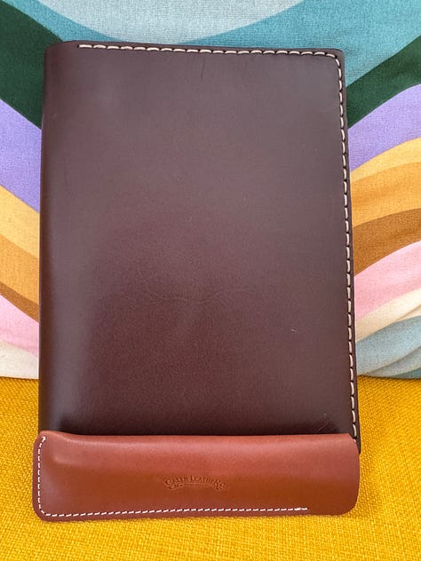 Brown leather notebook cover and page spreads