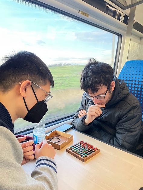 group of friends on train, in front of lake, and at football stadium