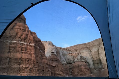 Three images of red rock hoodoos framed by the unzipped windows of a blue tent.