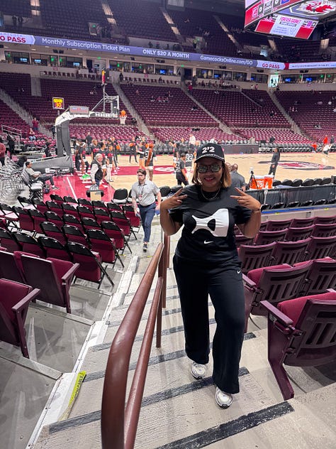 Me and A'ja's statue; custom art of A'ja; Dawn Staley, the artist of the painting shown, and A'ja; poster from the event I attended; A'ja decal on the arena; me and Janel; posing in my A'One shirt; A'ja's retired jersey; Dawn Staley Way