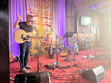 Andrew Peterson and other musicians playing - Esther Meek lecturing - the Northern Lights - Hayes Conference Centre in sunshine - printmaking workshop - selfie in front of Hutchmoot banner - Ruth Naomi Floyd singing - my copy of Every Moment Holy vol 3 with a print from it - Ted Turnau delivering the keynote