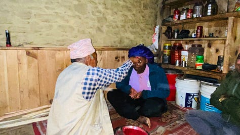 Grandma and grandpa pictured pressing tikka to my forehead.