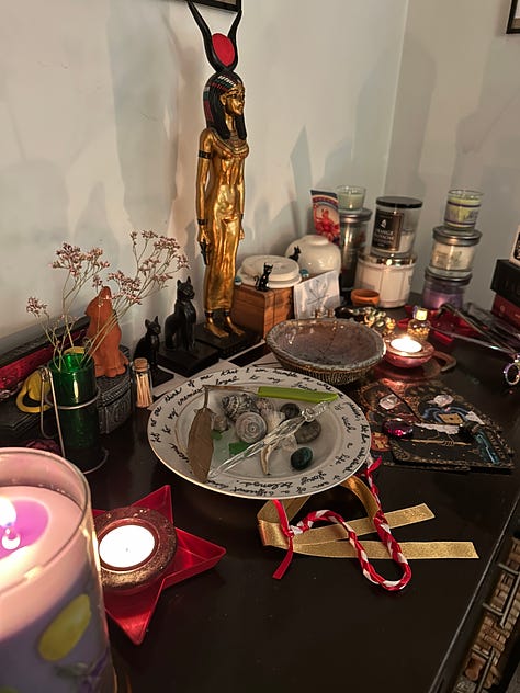 A pagan altar set with candles, ribbons, tarot cards, and votives | Cass in Star Wars cosplay in front of an A-Wing | Cass in a purple shirt and skirt in front of flowers in front of the EPCOT geodesic sphere