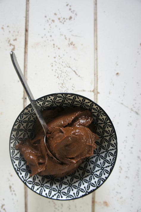 A gallery of photos, a loaf of rustic bread, a table with croissants, two seeded buns, a bowl of chocolate mousse, a scoop of vanilla and chocolate ice cream in a stemmed glass and a crunchy waffle topped with slices of fruit.