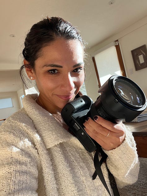 One row of three photos, left to right: Selfie of woman smiling and holding her digital camera, the sun streaming in through the living room and falling on her face; Photo of woman smiling holding up a copy of her book printed on a stack of computer printer paper; Mirror self-portrait of author in main house secondary bedroom wearing multiple layers of clothing, a headlamp, camera strung on her shoulder, and holding a camera tripod that is taller than her 5’2 frame.