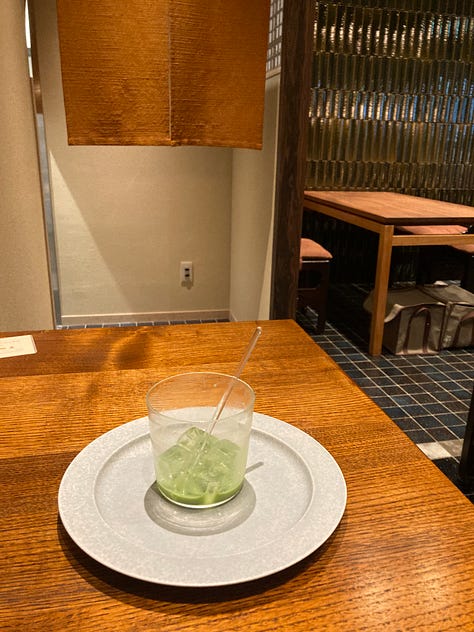 Takashi Murakami sculpture at Kyocera Museum, witch miffy in a blue background, free gaza embroidered sign at sanjo bridge in kyoto, ice cream with a link chocolate bear on top, emoty glass of matcha with some bits of green and ice still there, sculpture of a deer surrounded by greenery