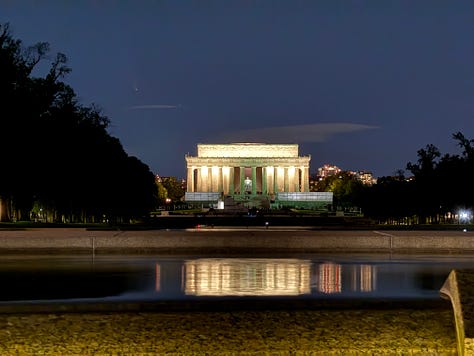 The Jefferson Memorial illuminated at night, a prominent U.S. landmark with its classical dome and columns. A close-up of the Lincoln Memorial statue, showing Abraham Lincoln seated, with part of the inscription visible above him. A nighttime view of the Lincoln Memorial, with its reflection visible on the water of the reflecting pool in front of it.