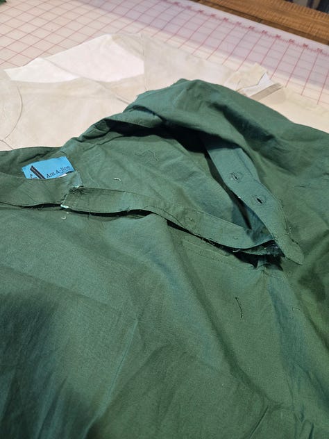 A green and tan shirt partially dissassembled.