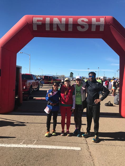 finish line posing photo, an older woman in a blue shirt holds a medal, and a group of people in christmas pajamas pose in the park, fun run, Cloudcroft, New Mexico