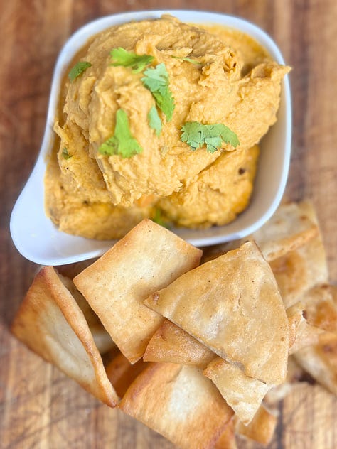 Sweet potato hummus with pita chips and chickpeas and sweet potato in a food processor