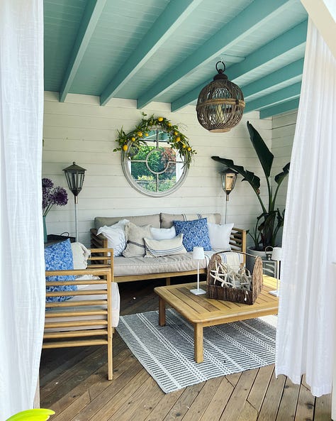 Utility room, garden canop, porch, verandah, flowers on a table in an English garden. 