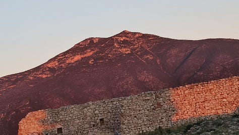 mountain sunrise, sea and compass
