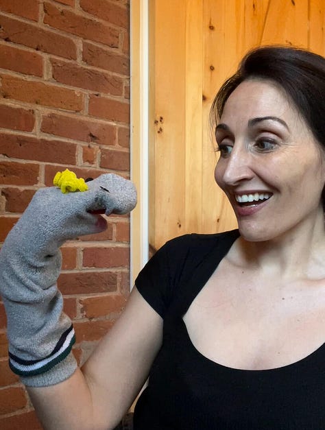 Hollay Ghadery holding a grey sock puppet