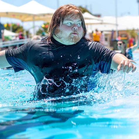 People splash about, embrace and strike fun poses at Murray Bridge's swimming pool.