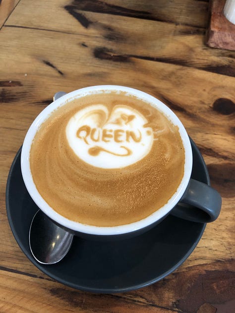 An image of a woman drinking a glass of wine, a coffee with the word queen on it and two lunches