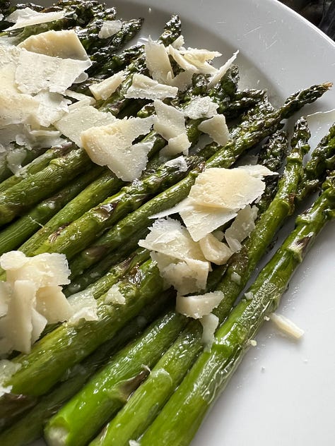 An asparagus tart, asparagus and crumbled Parmesan, asparagus, crispy smashed potatoes and green dip