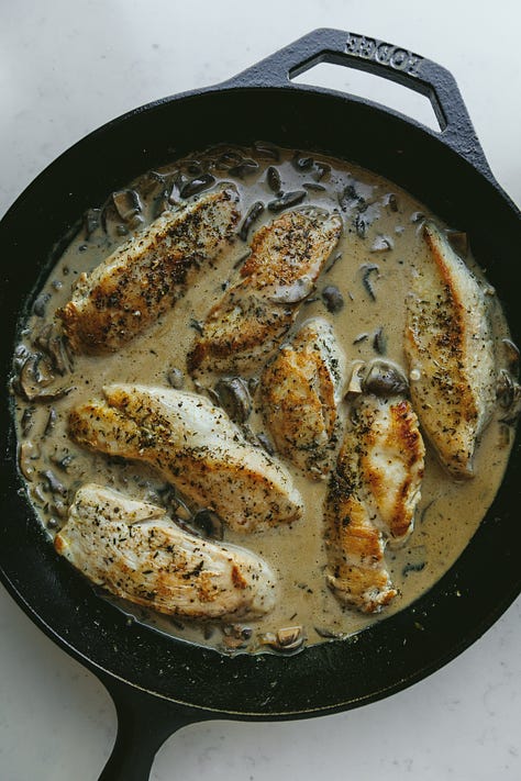 Creamy mushroom chicken in a skillet and on a plate with cauliflower mash.