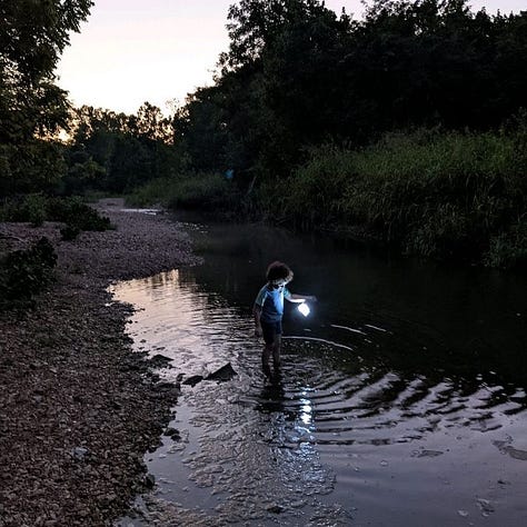 Three images show different views of creeks. The first image shows a shallow creekbed. The second shows large rocks and foliage. The final image shows a small child holding a lantern, wading through a creek at dusk.