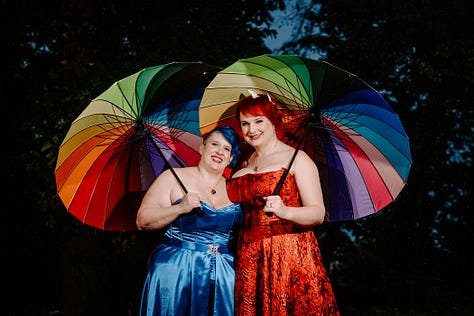 Three poctures of Doc impossible and B--, her wife. B-- wears a blue corset with an overskirt, and Doc is in a floor-length red zilk brocade strapless dress.