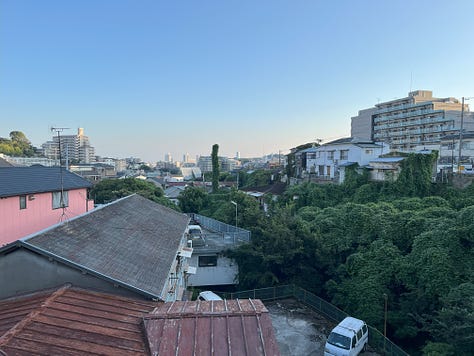 Pictures of riverside, a train leaving a small station, a passageway so small it looks like a culvert, and the suburbs of Kobe