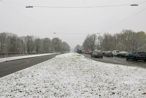 Snowy photos showing paths through an old cemetery and a wide, hostile looking ring road.