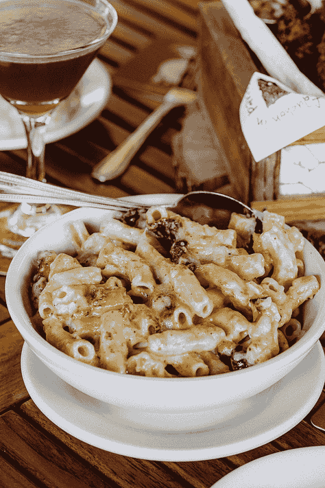 3 photos from L to R: external photo of Zingerman's Roadhouse Restaurant; bowl of mac & cheese; table with fried chicken and bowl of mac & cheese