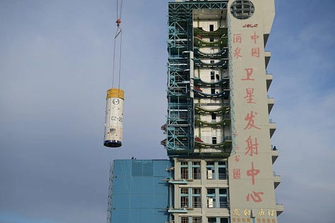 Vehicle hardware for the Long March 2D Y101 mission being transported to and stacked on the launch pad.