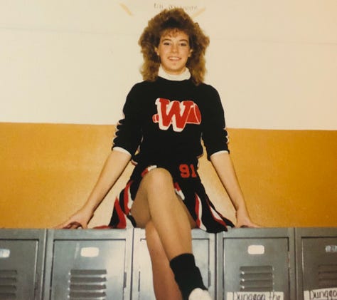 The author in three different black and orange cheer uniforms.