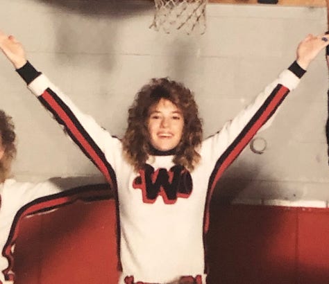 The author in three different black and orange cheer uniforms.
