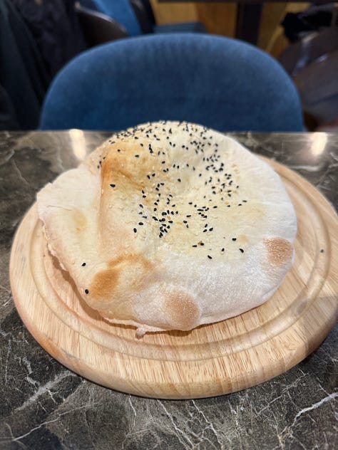 Three images from left to right, a pita bread on a wooden plate; hummus with lamb, bell peppers and cucumber; the turnip drink with a red liquid