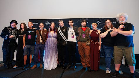 1: Cass on stage with the Halcy-Con event team, all arm-in-arm | 2: A massive circle of people hugging and swaying to a song; Cass is visible in the foreground, definitely trying to hide the fact that she's weeping by tucking her head in a friend's shoulder | 3: Cass beneath an arch of lightsabers, hand held to her mouth because there's really no hiding that she's crying this time.